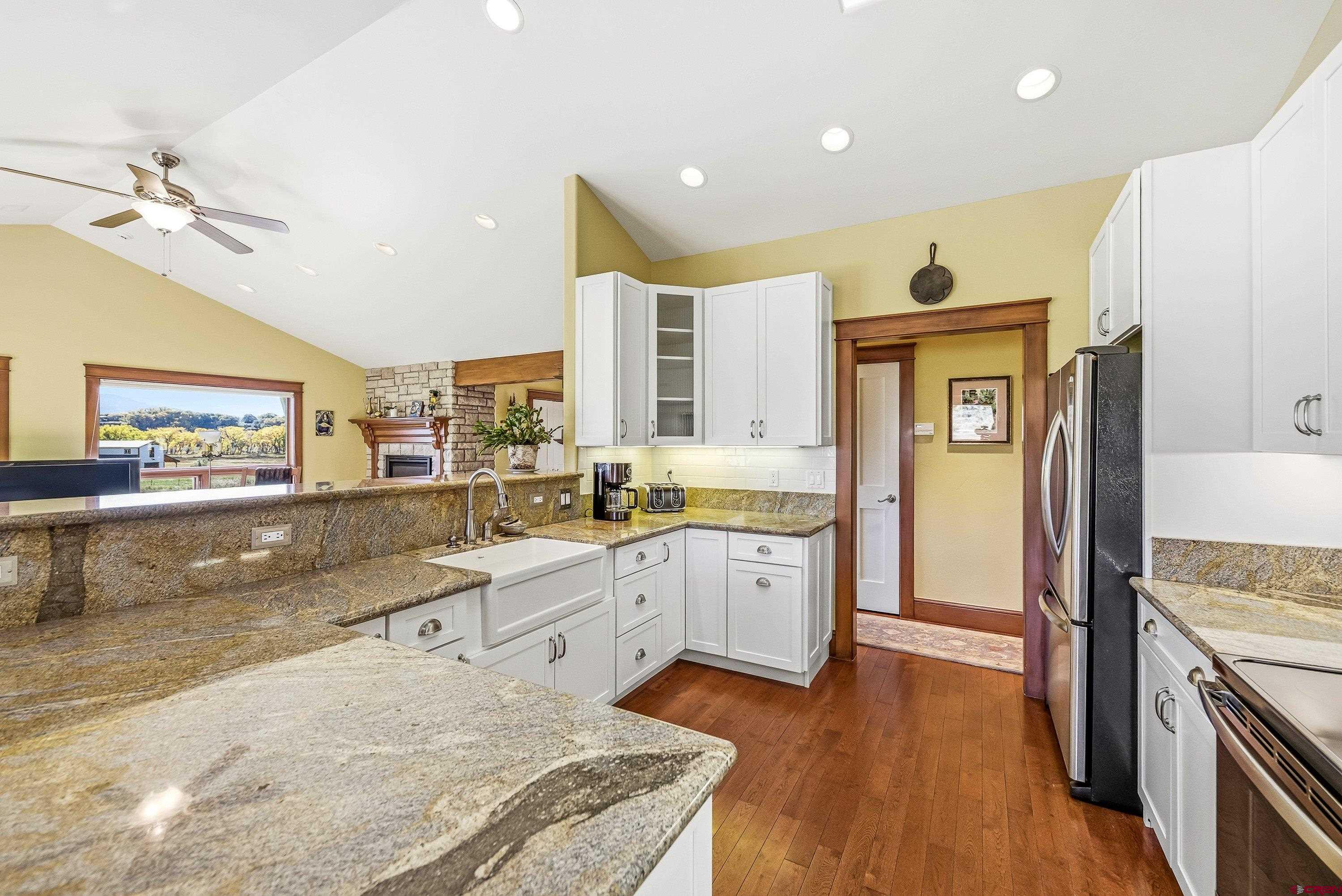36639 M50 Road Hotchkiss, CO 81419 - Photo 22 of 45 a large kitchen with granite countertop a sink and dishwasher stove top oven