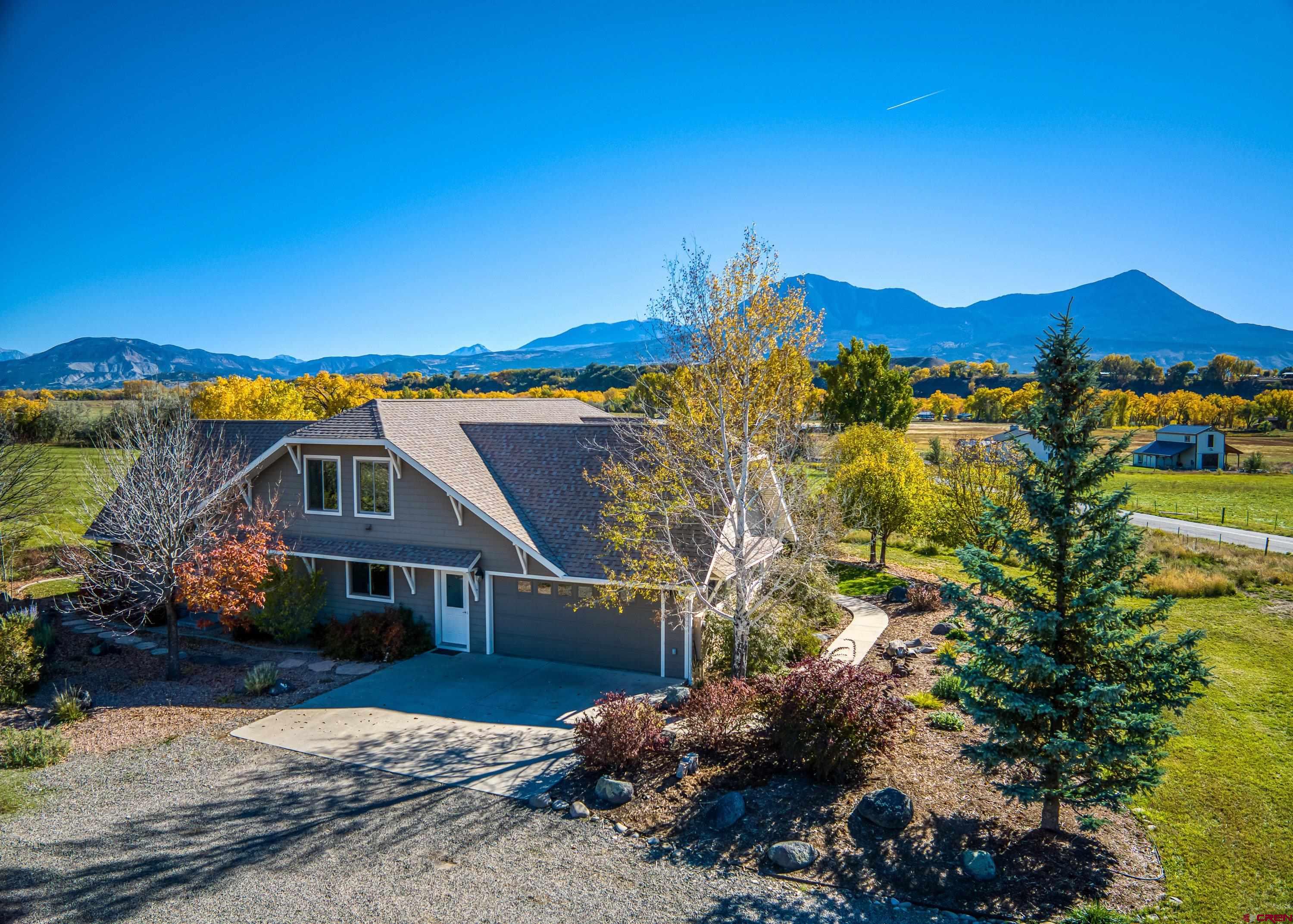 36639 M50 Road Hotchkiss, CO 81419 - Photo 6 of 45 a view of a house with a yard and a large tree