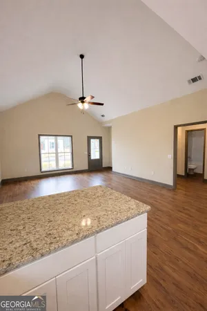 a view of empty room with wooden floor