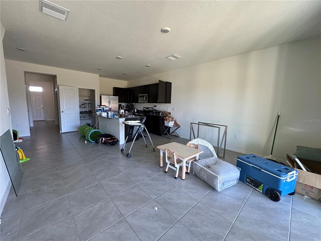 16641 Grotto Steam Place Wimauma, FL 33598 - Photo 3 of 17 a living room with furniture and a flat screen tv