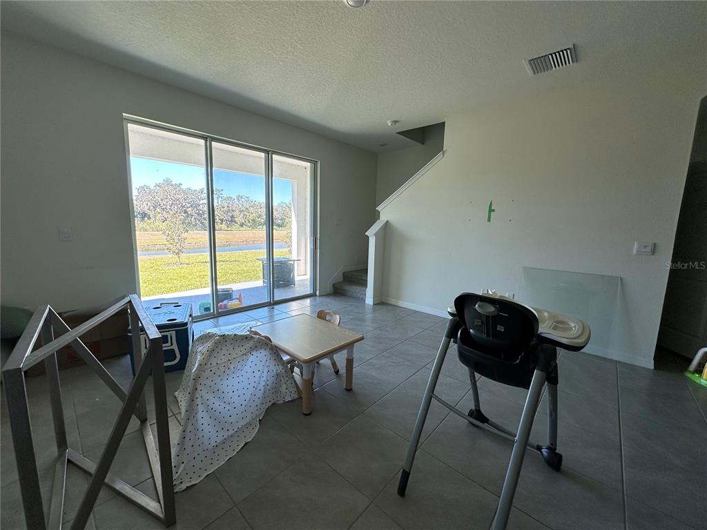 16641 Grotto Steam Place Wimauma, FL 33598 - Photo 8 of 17 a view of a workspace with furniture and a window