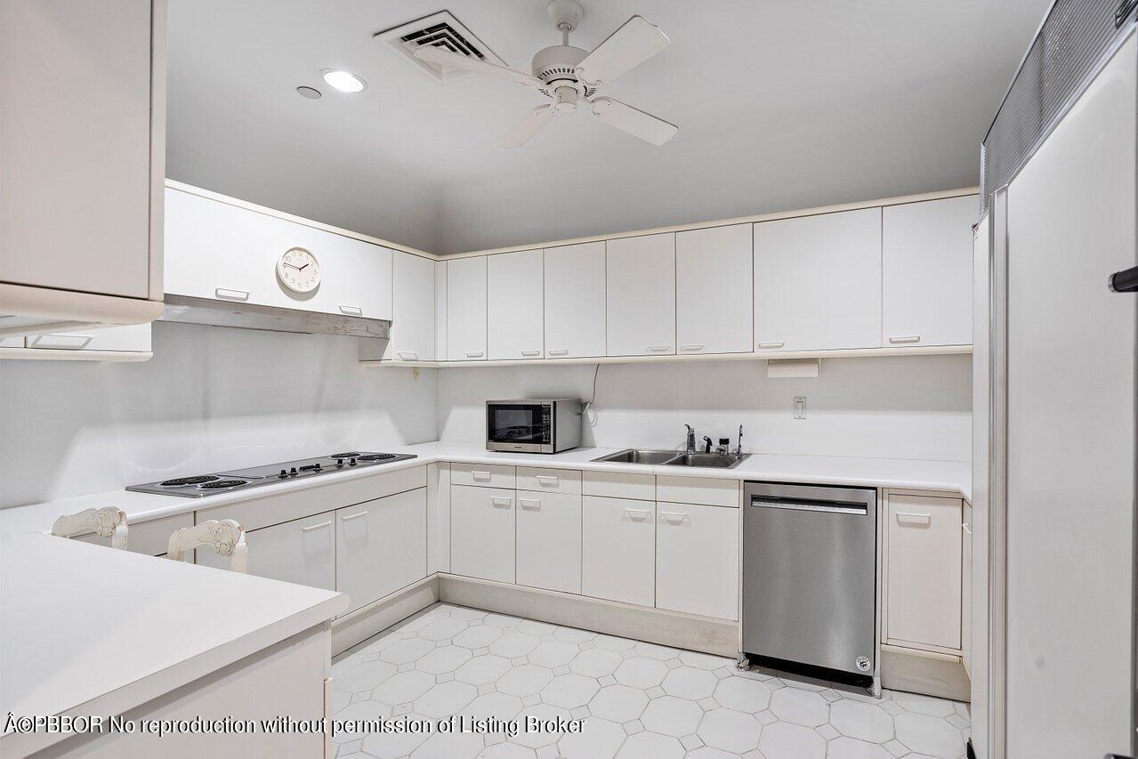 2 North Breakers Row, Unit S43 Palm Beach, FL 33480 - Photo 25 of 37 a kitchen with white cabinets a sink and white appliances