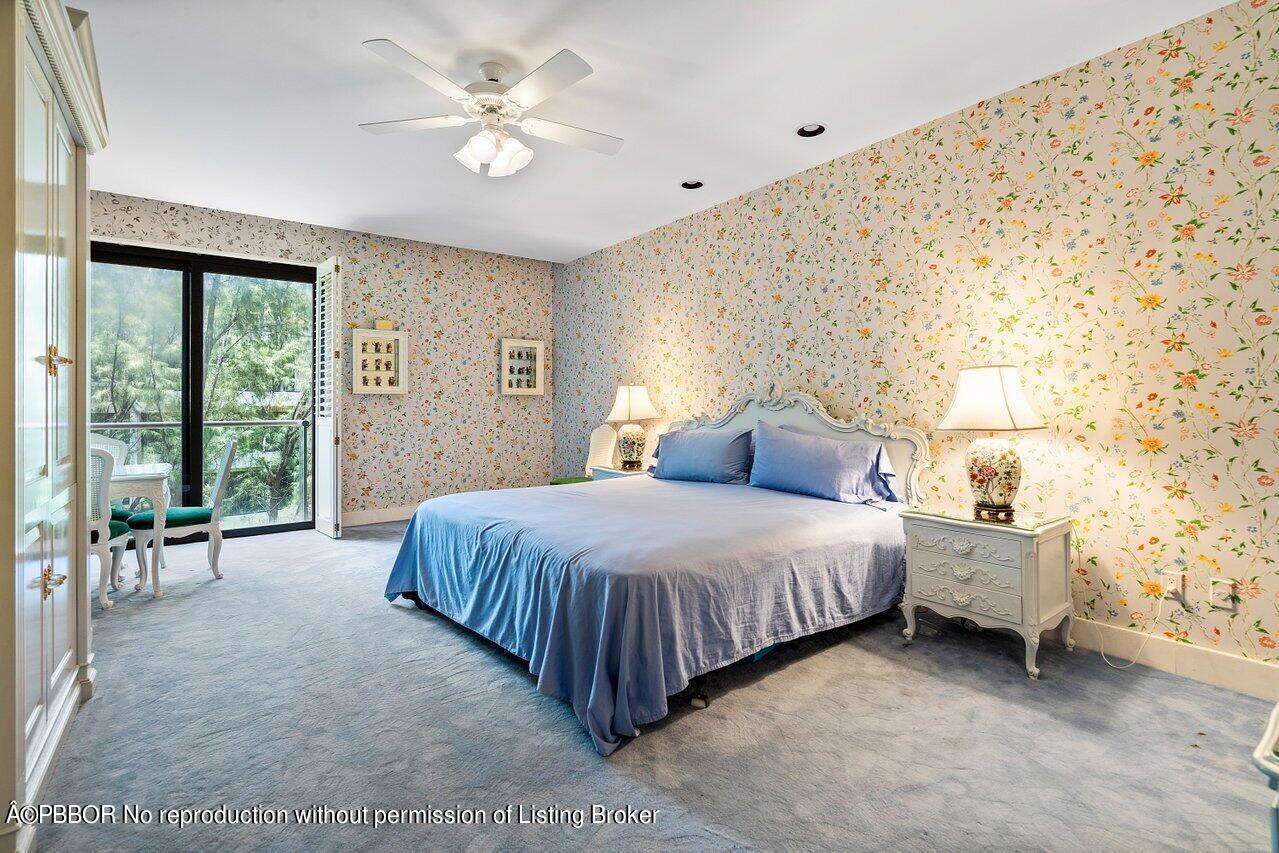 2 North Breakers Row, Unit S43 Palm Beach, FL 33480 - Photo 27 of 37 a spacious bedroom with a bed and a chandelier