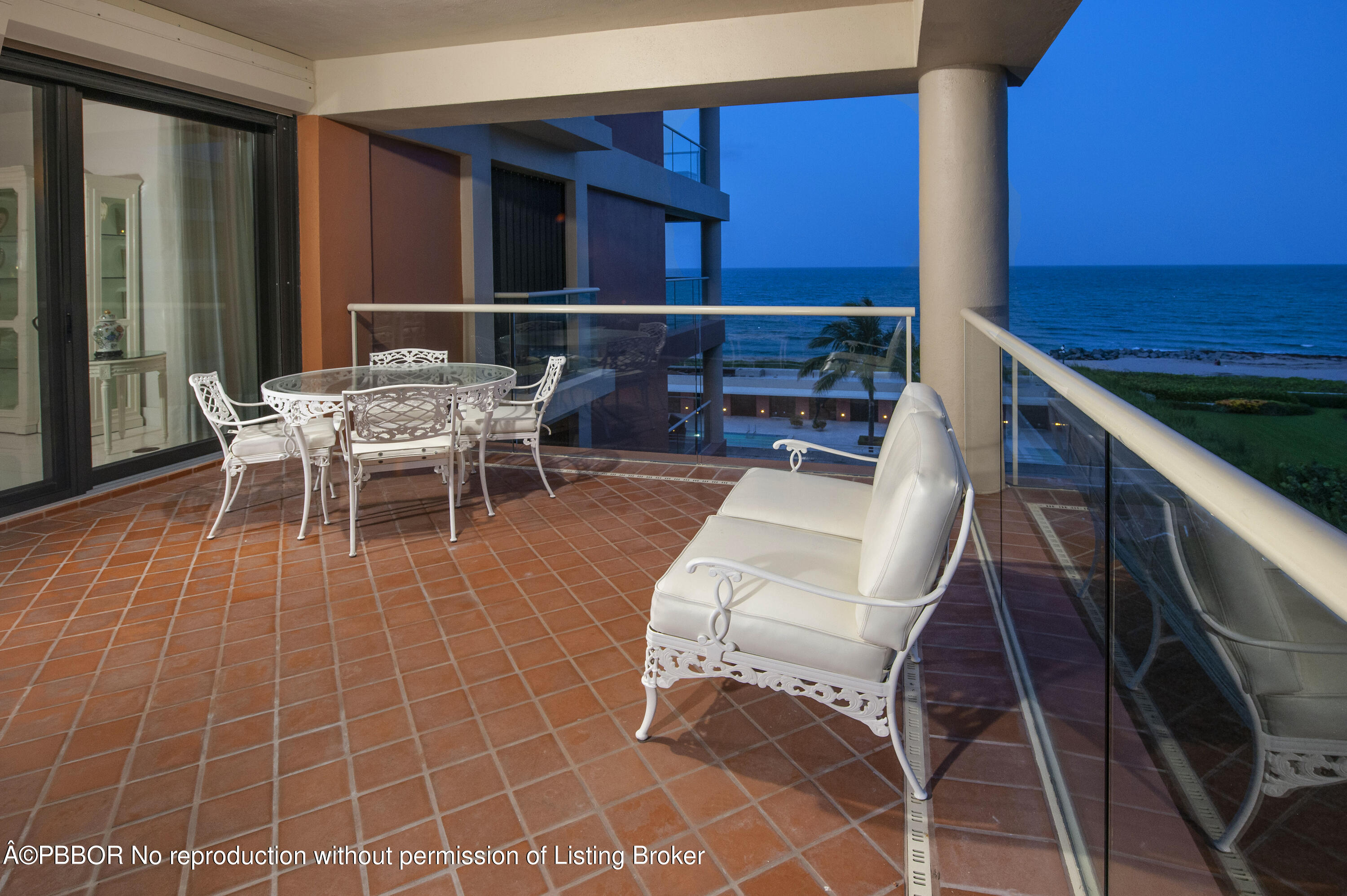 2 North Breakers Row, Unit S43 Palm Beach, FL 33480 - Photo 34 of 37 a view of a patio with table and chairs with wooden floor and fence