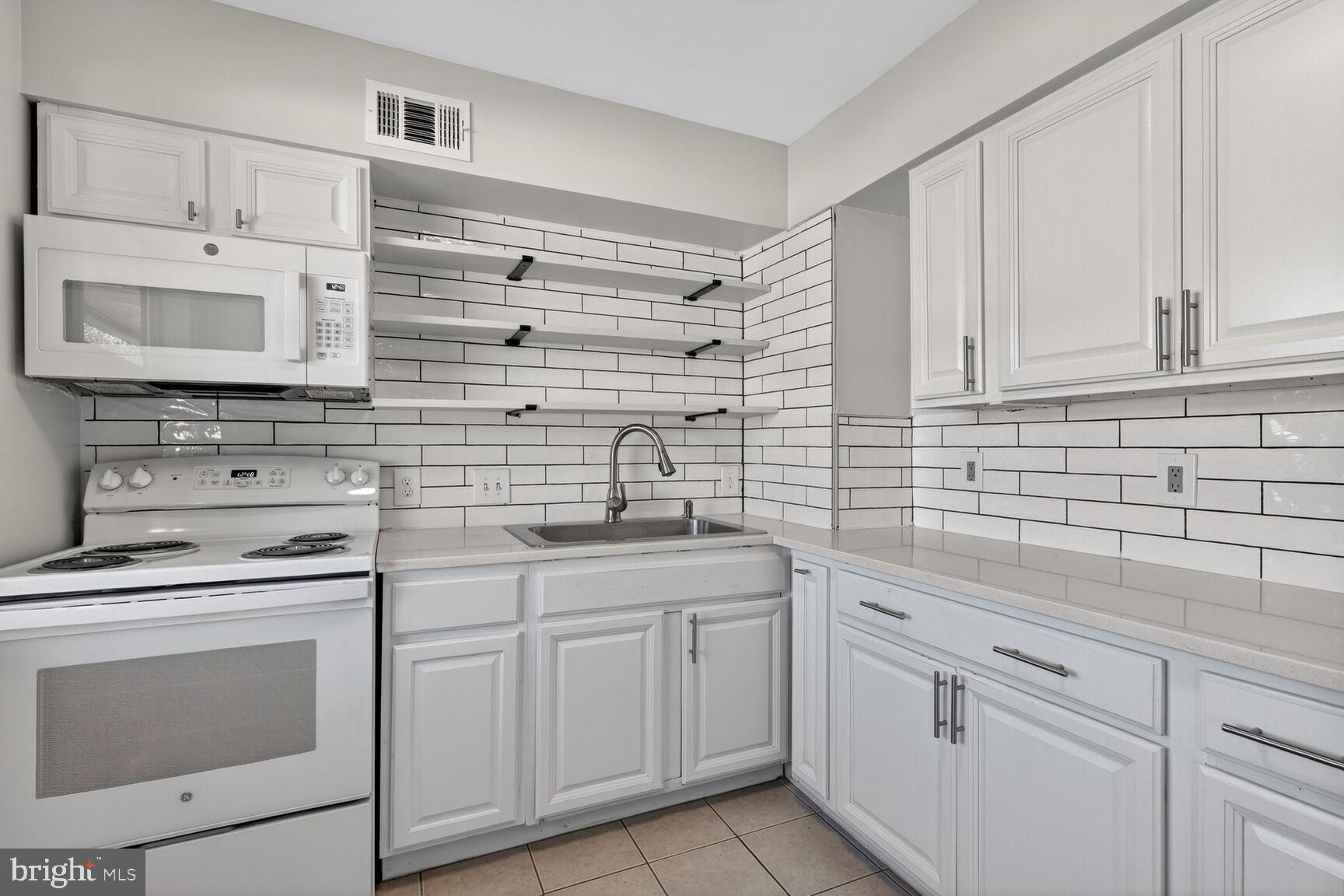 6307 Cottonwood Drive Alexandria, VA 22310 - Photo 12 of 28 a kitchen with cabinets stainless steel appliances and sink
