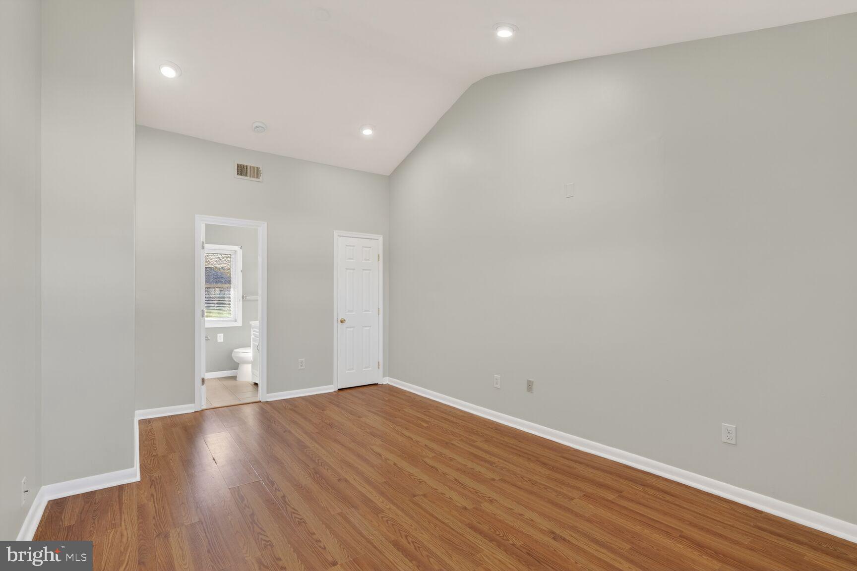 6307 Cottonwood Drive Alexandria, VA 22310 - Photo 14 of 28 an empty room with wooden floor and windows