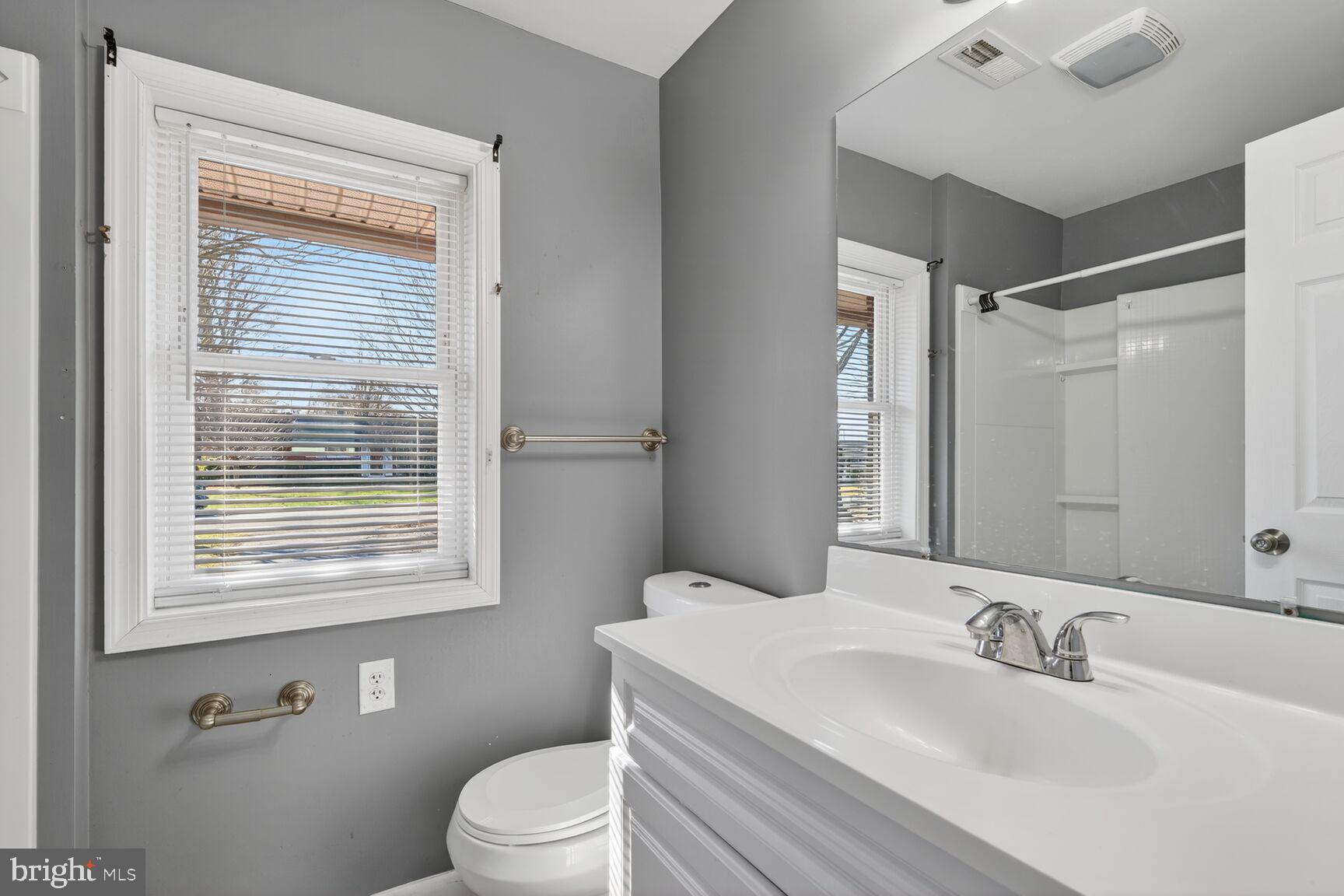 6307 Cottonwood Drive Alexandria, VA 22310 - Photo 16 of 28 a bathroom with a sink vanity mirror and toilet