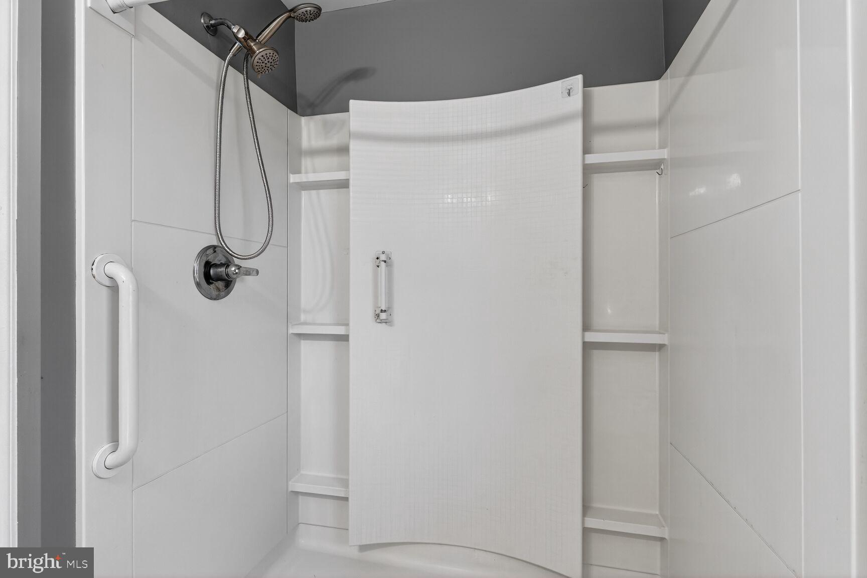 6307 Cottonwood Drive Alexandria, VA 22310 - Photo 17 of 28 a bathroom with a glass shower door