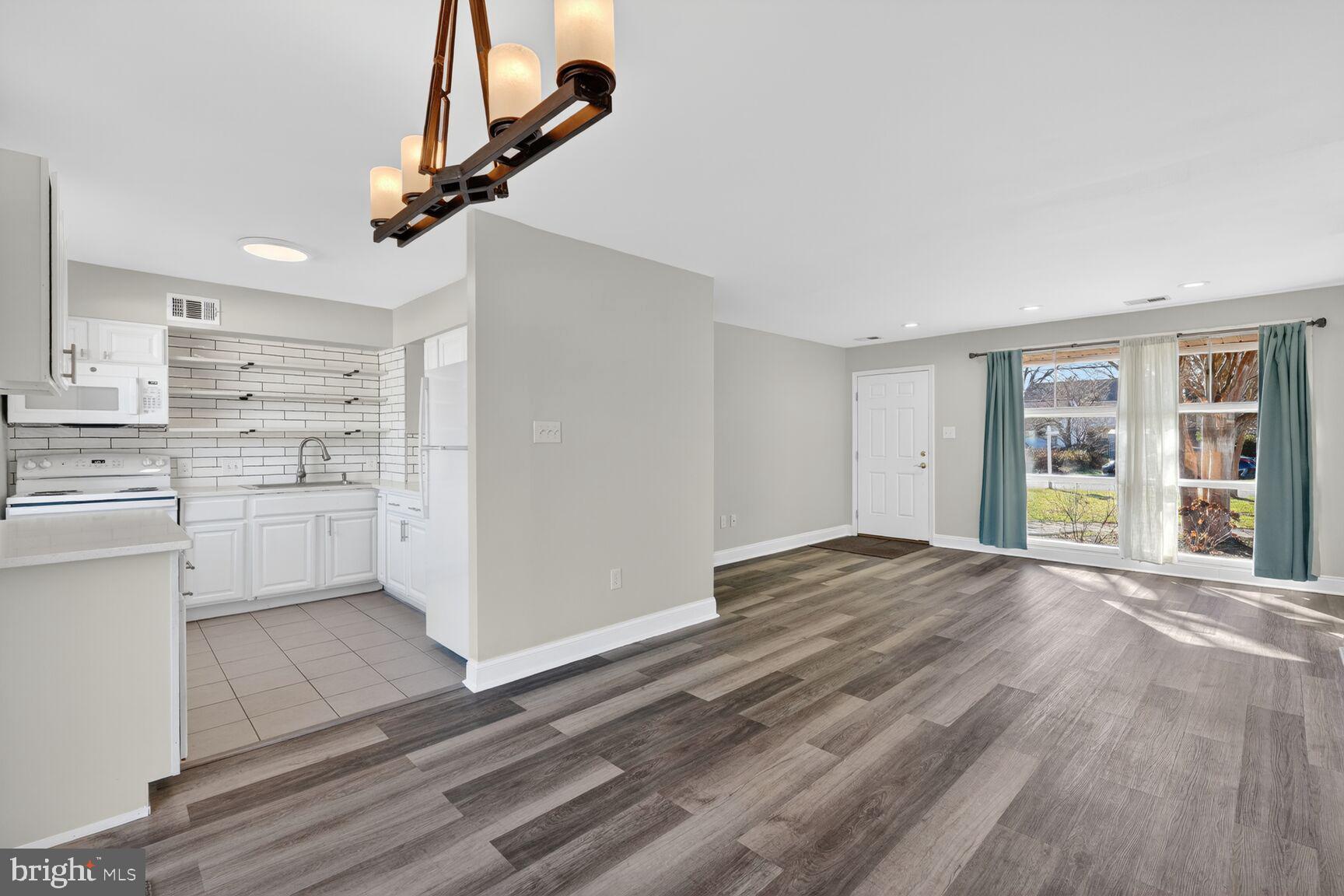 6307 Cottonwood Drive Alexandria, VA 22310 - Photo 19 of 28 a view of empty room with wooden floor and window
