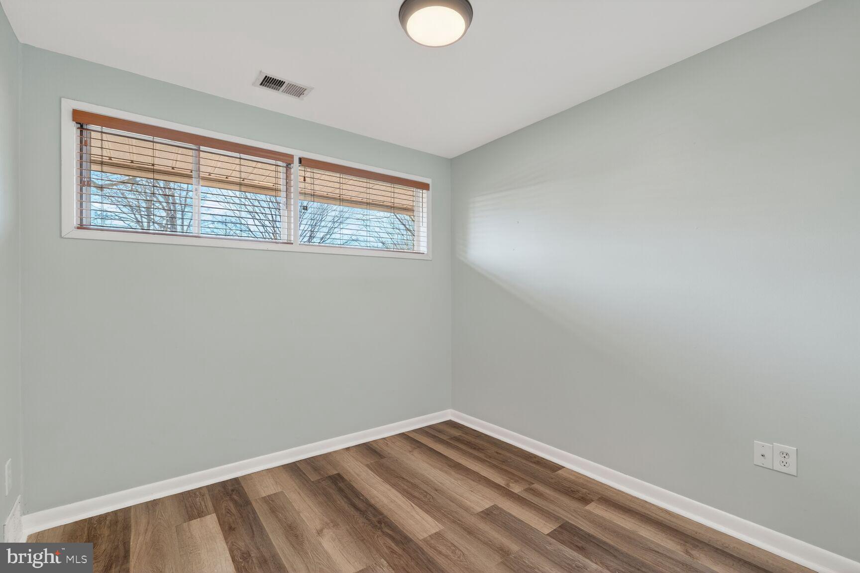6307 Cottonwood Drive Alexandria, VA 22310 - Photo 20 of 28 a view of an empty room with wooden floor and a window