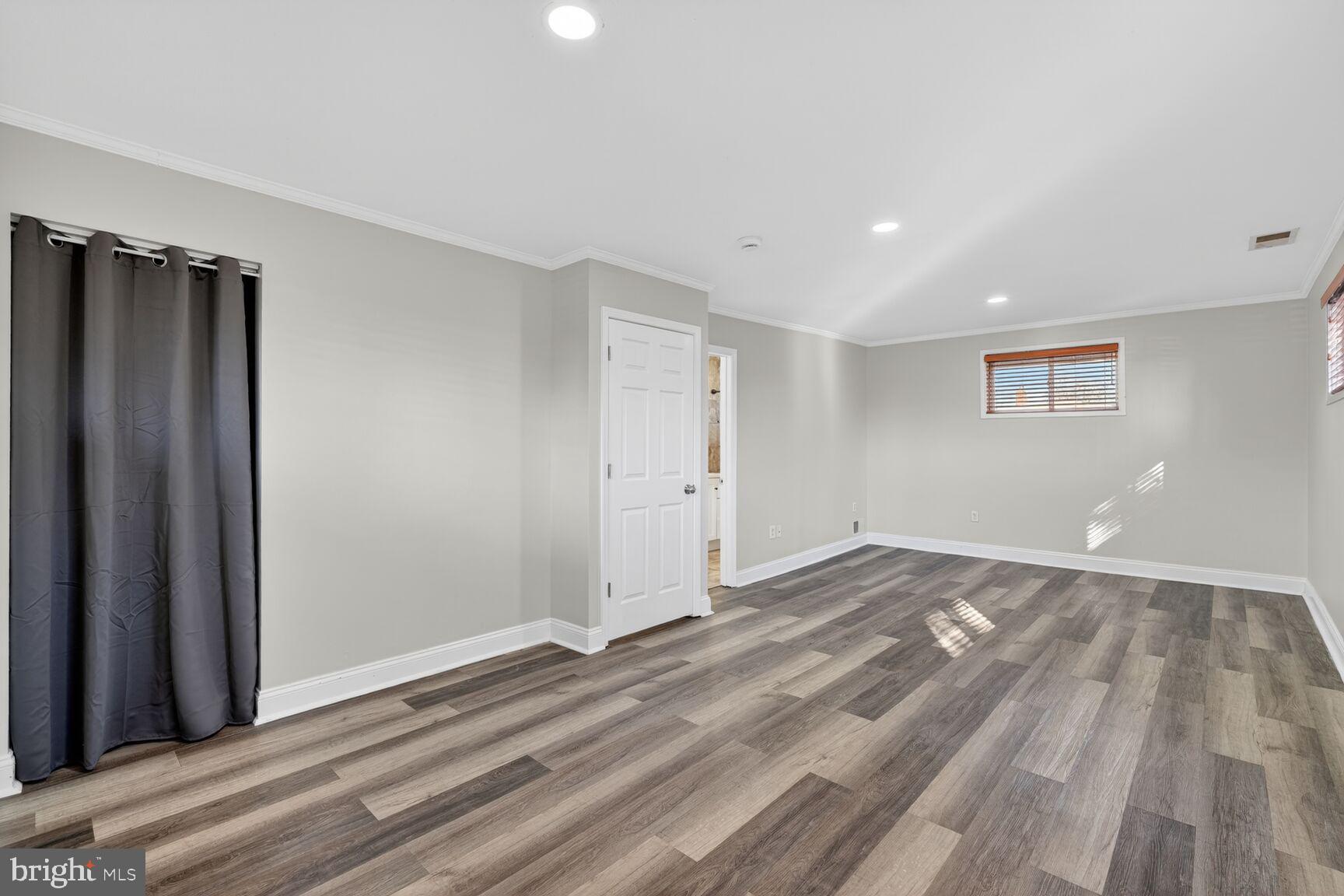 6307 Cottonwood Drive Alexandria, VA 22310 - Photo 23 of 28 a view of an empty room with wooden floor and a window