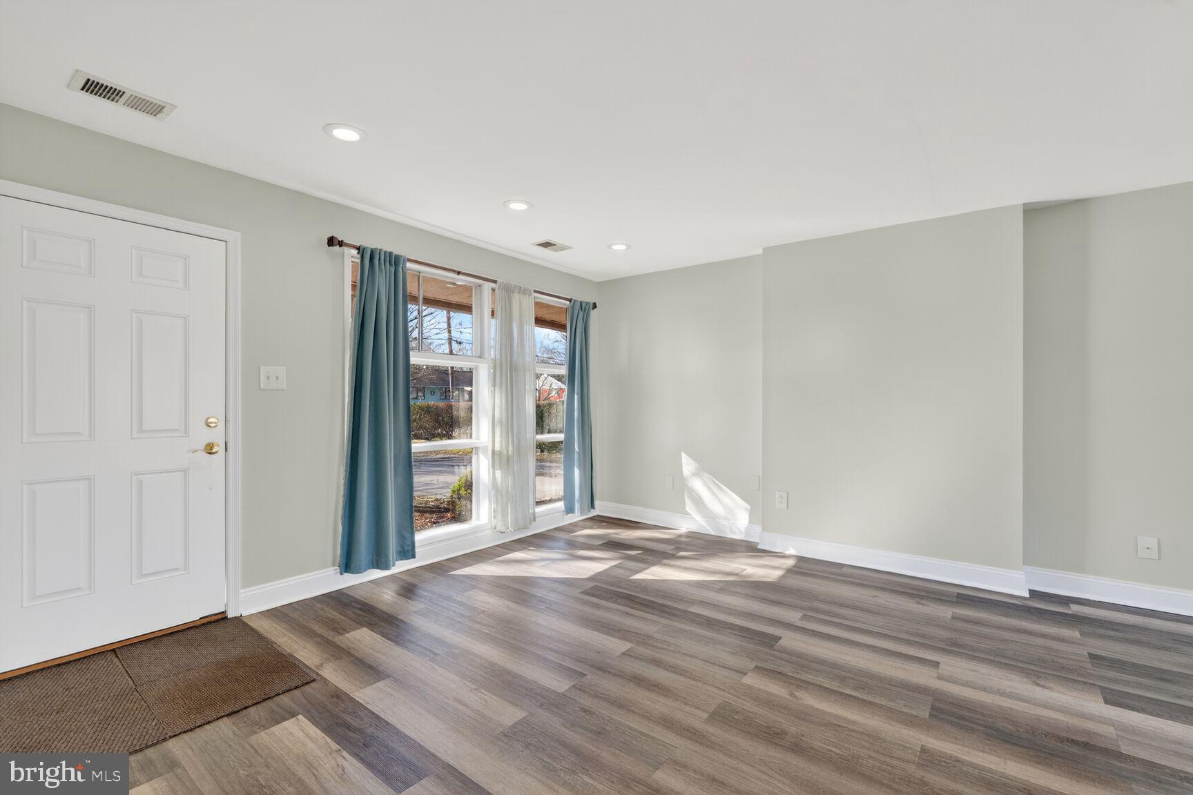 6307 Cottonwood Drive Alexandria, VA 22310 - Photo 4 of 28 a view of an empty room with wooden floor and a window