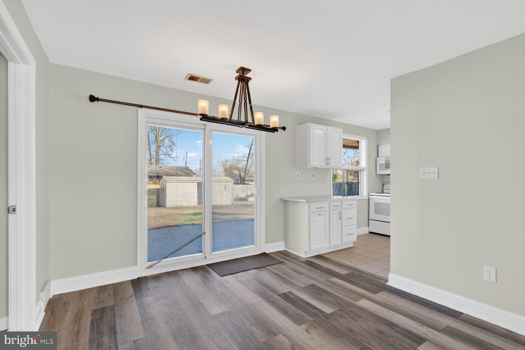 6307 Cottonwood Drive Alexandria, VA 22310 - Photo 6 of 28 a view of a kitchen and an empty room with wooden floor