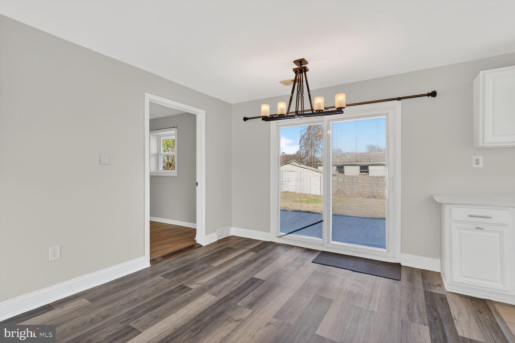 6307 Cottonwood Drive Alexandria, VA 22310 - Photo 7 of 28 wooden floor in an empty room with a window
