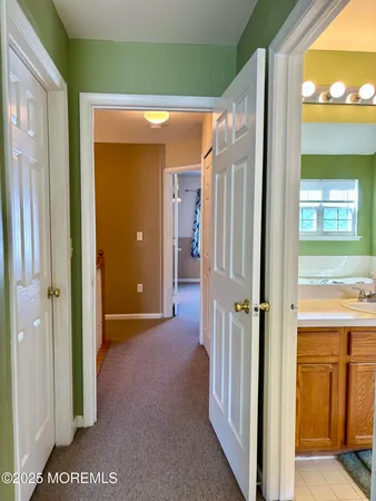 a view of a hallway with wooden shelves