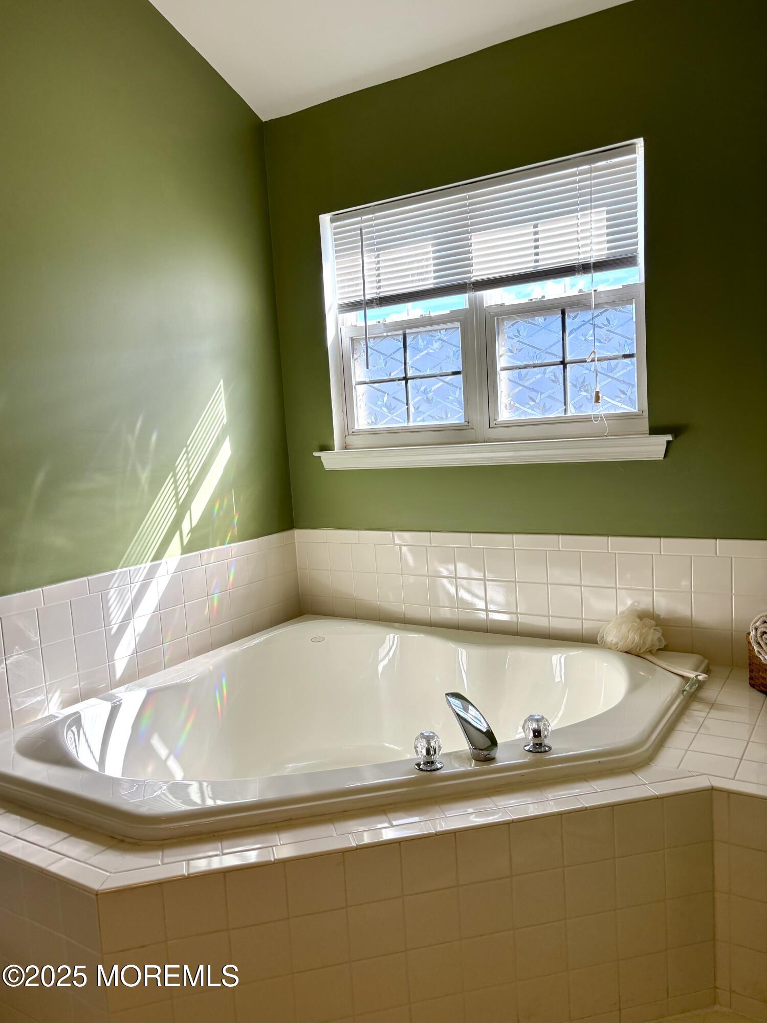 39 Rozalyn Lane, Unit 141 South Amboy, NJ 08879 - Photo 13 of 18 a white bath tub sitting in a bathroom