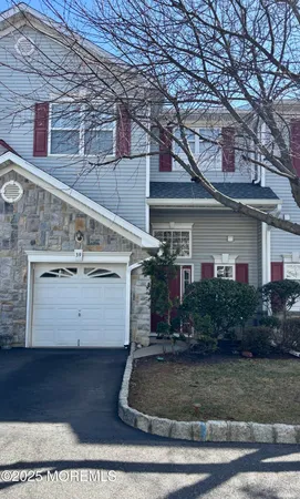 a view of a white house with large windows