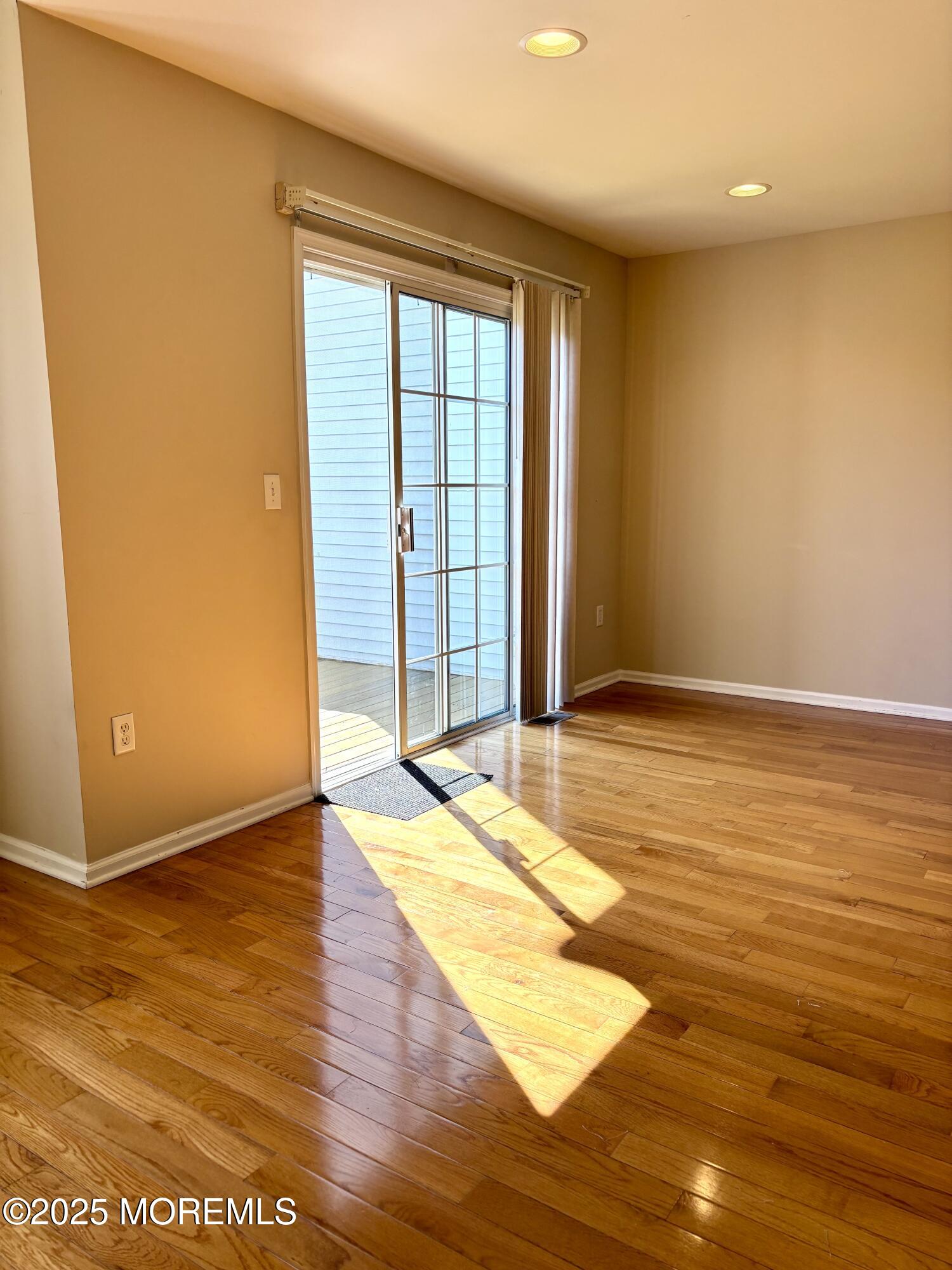 39 Rozalyn Lane, Unit 141 South Amboy, NJ 08879 - Photo 4 of 18 a view of an empty room with wooden floor and a window