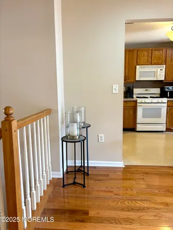 a view of kitchen with wooden floor and electronic appliances