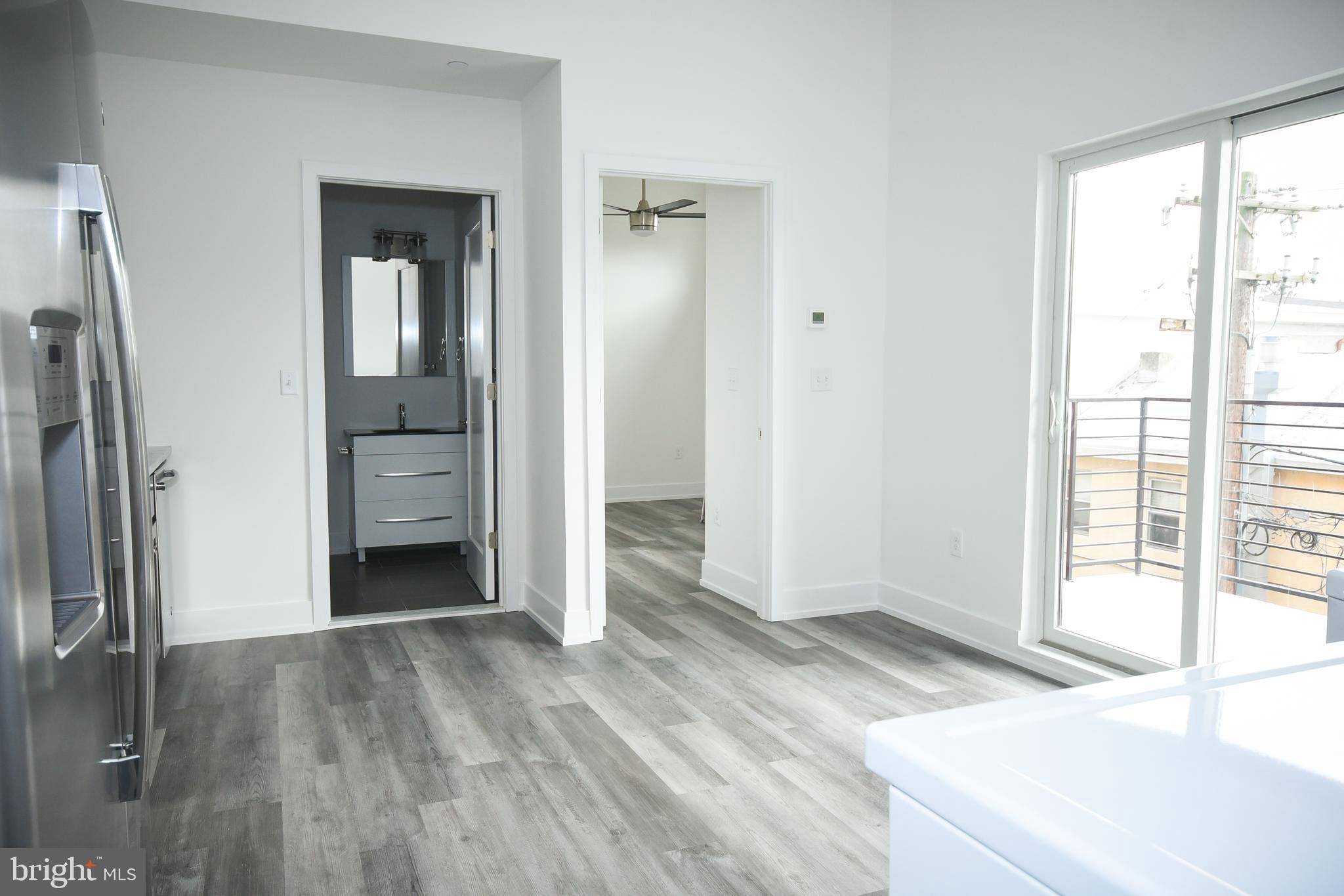6162 Ridge Avenue, Unit 201 Philadelphia, PA 19128 - Photo 11 of 14 an empty room with windows and entrance