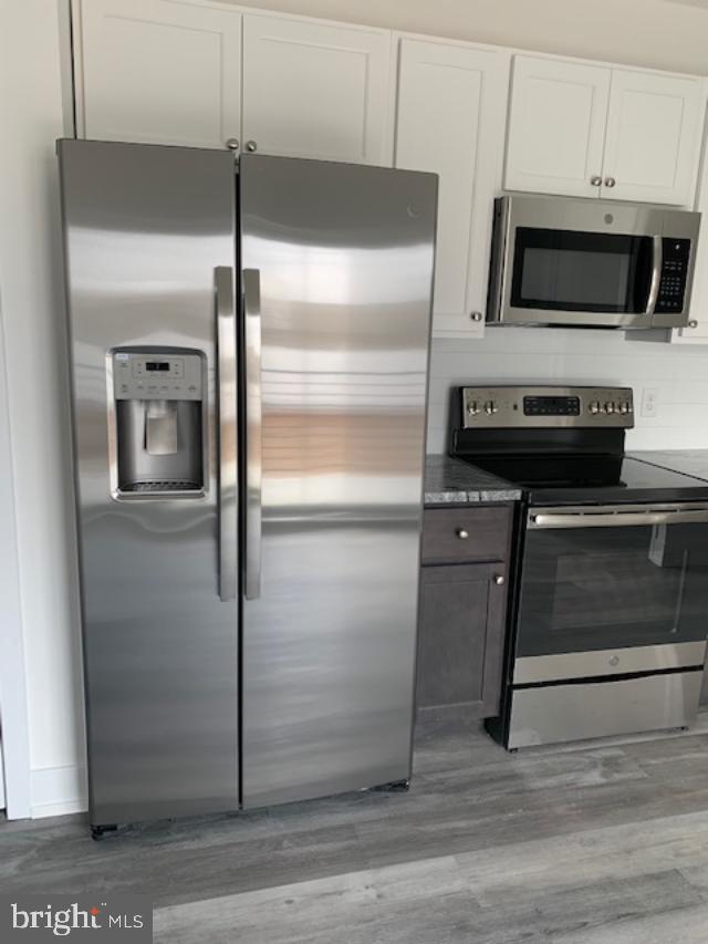6162 Ridge Avenue, Unit 201 Philadelphia, PA 19128 - Photo 8 of 14 a kitchen with a refrigerator and a stove