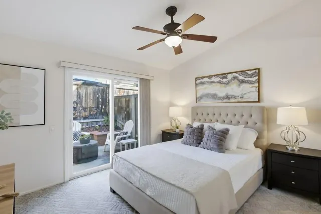 a bedroom with a large bed and a large window