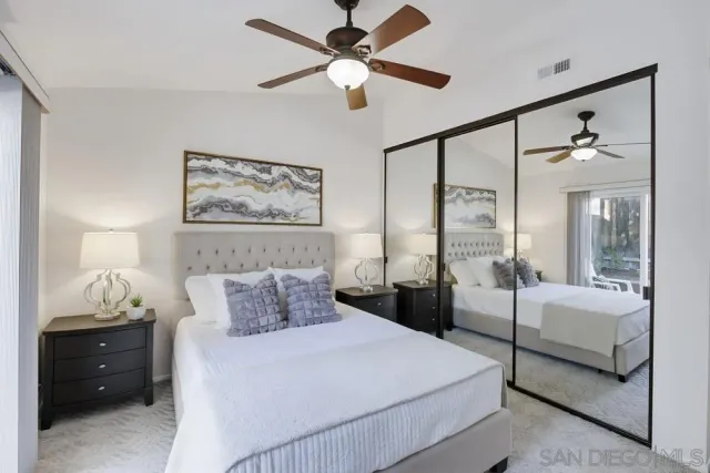 a bedroom with a bed and a painting on the wall