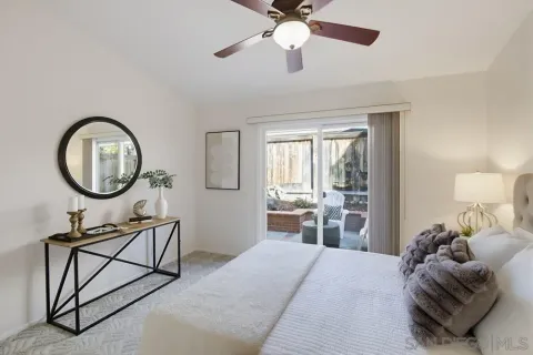 a bedroom with furniture and a mirror