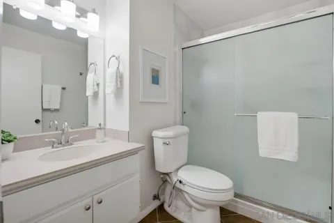 a bathroom with a sink toilet and shower