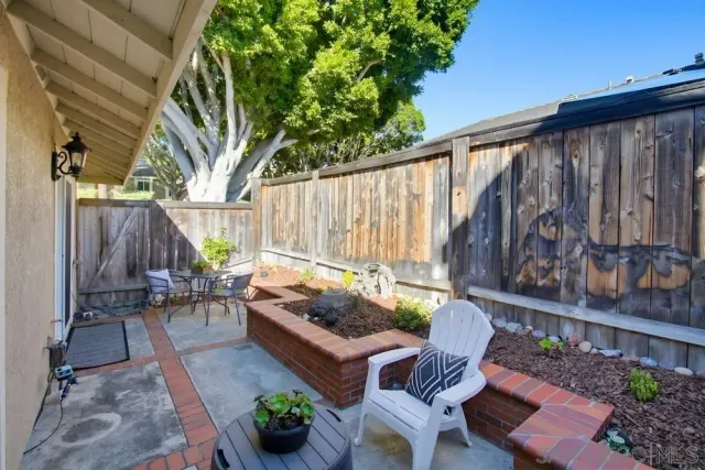 a backyard of a house with outdoor seating