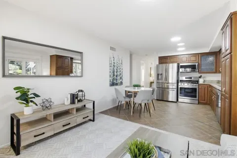 a living room with furniture kitchen and a table