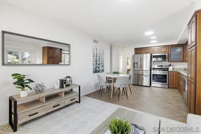a living room with furniture kitchen and a table