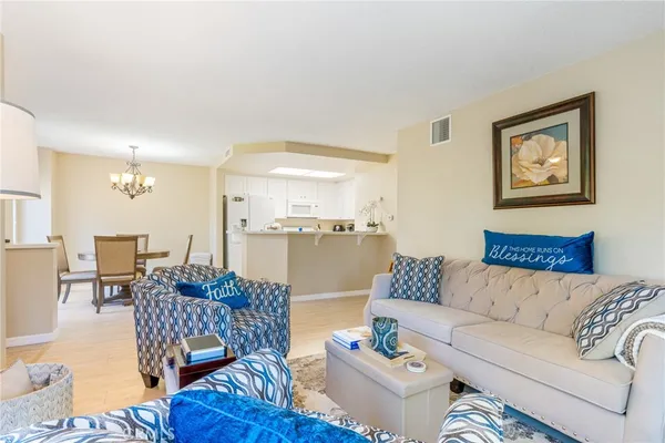 a living room with furniture and kitchen view