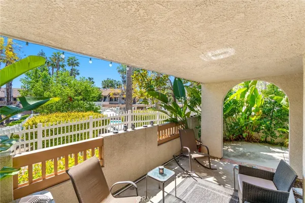 a view of a chairs and table in patio