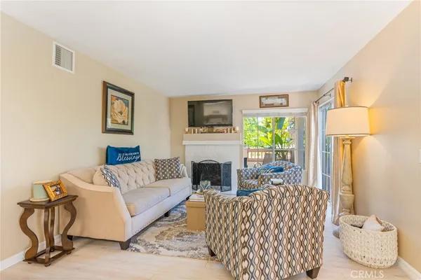 a living room with furniture fireplace and window