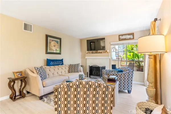 a living room with furniture a flat screen tv and a fireplace