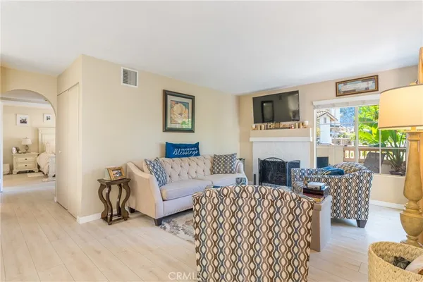 a living room with fireplace furniture and a flat screen tv