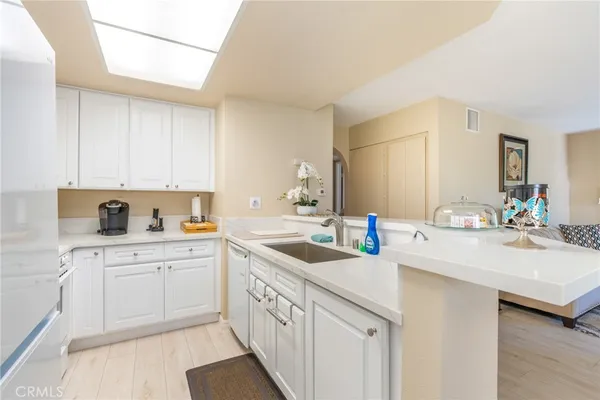 a kitchen with sink cabinets and white appliances