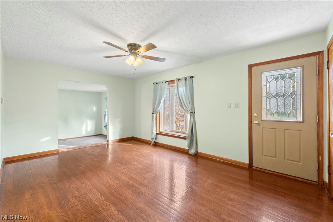 227 South Messner Road New Franklin, OH 44319 - Photo 13 of 44 Foyer entrance with light hardwood / wood-style flooring, ceiling fan, and a textured ceiling