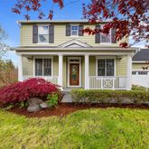 a front view of a house with a garden and porch