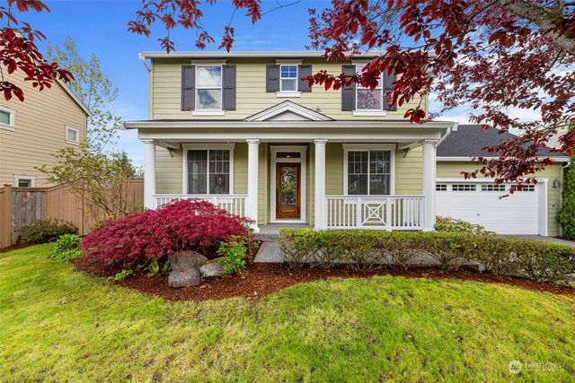 a front view of a house with a garden and porch
