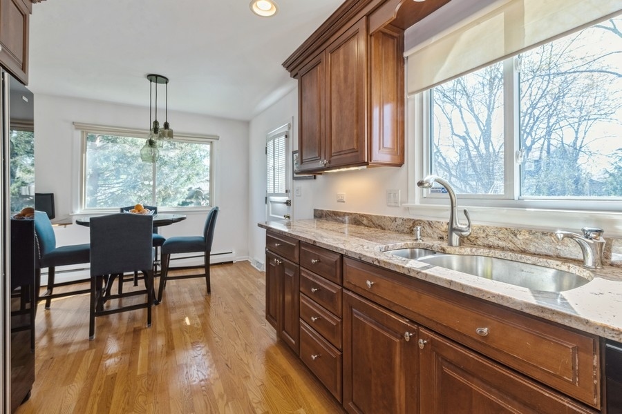 90 Ferndale Road Deerfield, IL 60015 - Photo 8 of 30 a kitchen with sink cabinets and wooden floor