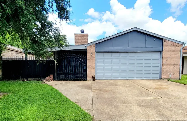 a view of house with backyard and garden