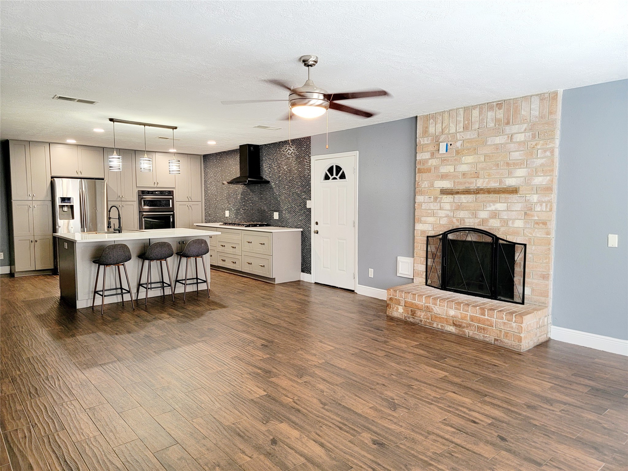 4170 Amir Street Houston, TX 77072 - Photo 2 of 10 a view of a livingroom with furniture a ceiling fan and wooden floor