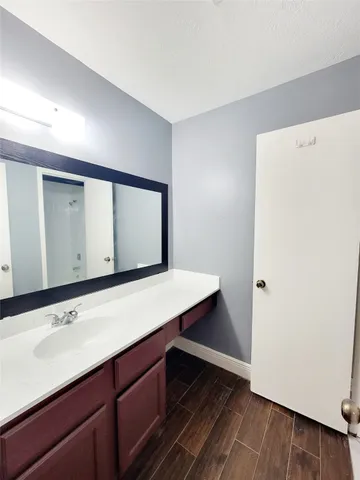 a bathroom with a sink a mirror and a shower