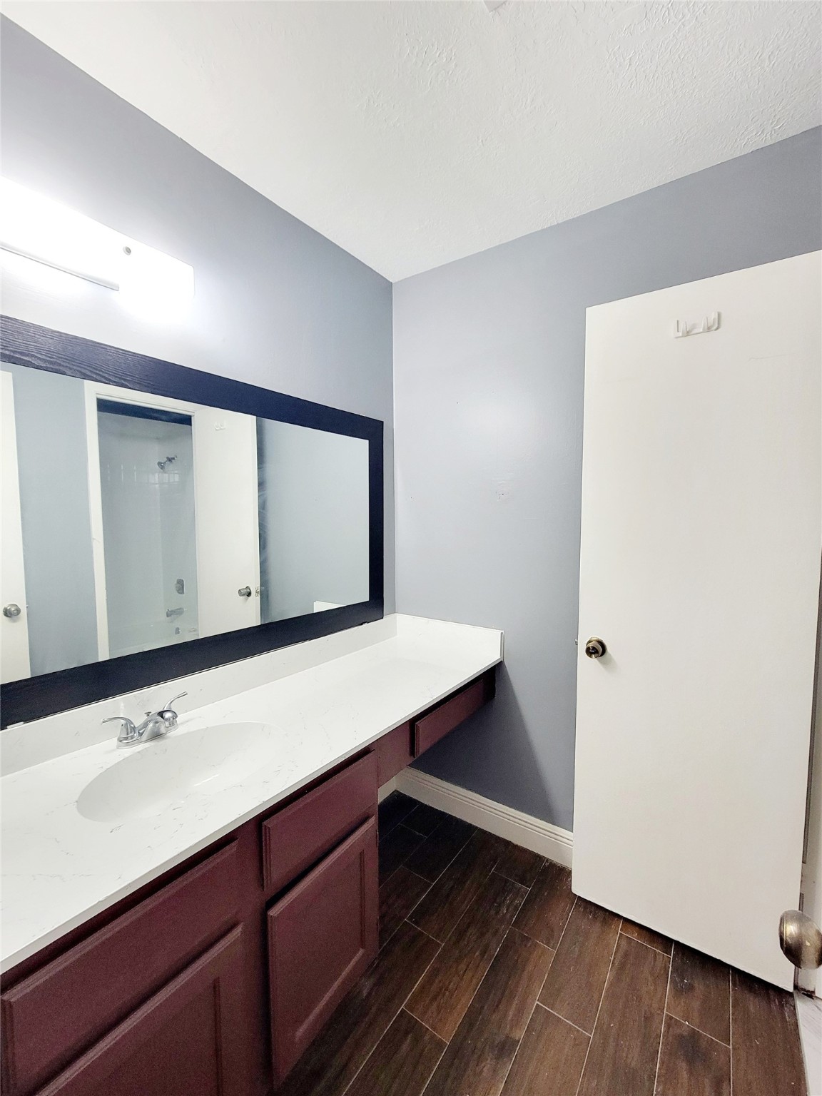 4170 Amir Street Houston, TX 77072 - Photo 6 of 10 a bathroom with a sink a mirror and a shower