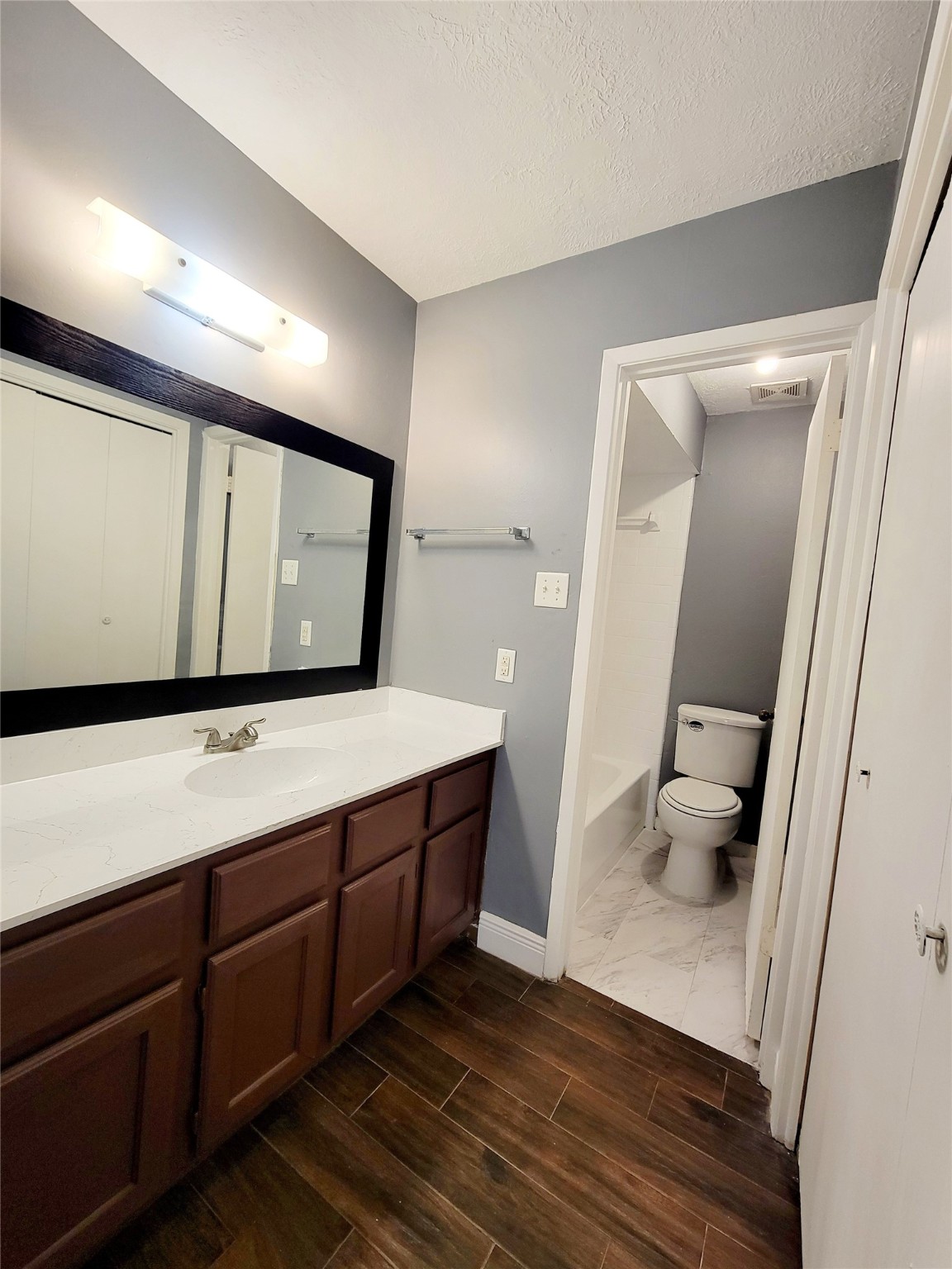 4170 Amir Street Houston, TX 77072 - Photo 8 of 10 a bathroom with a sink a toilet and mirror