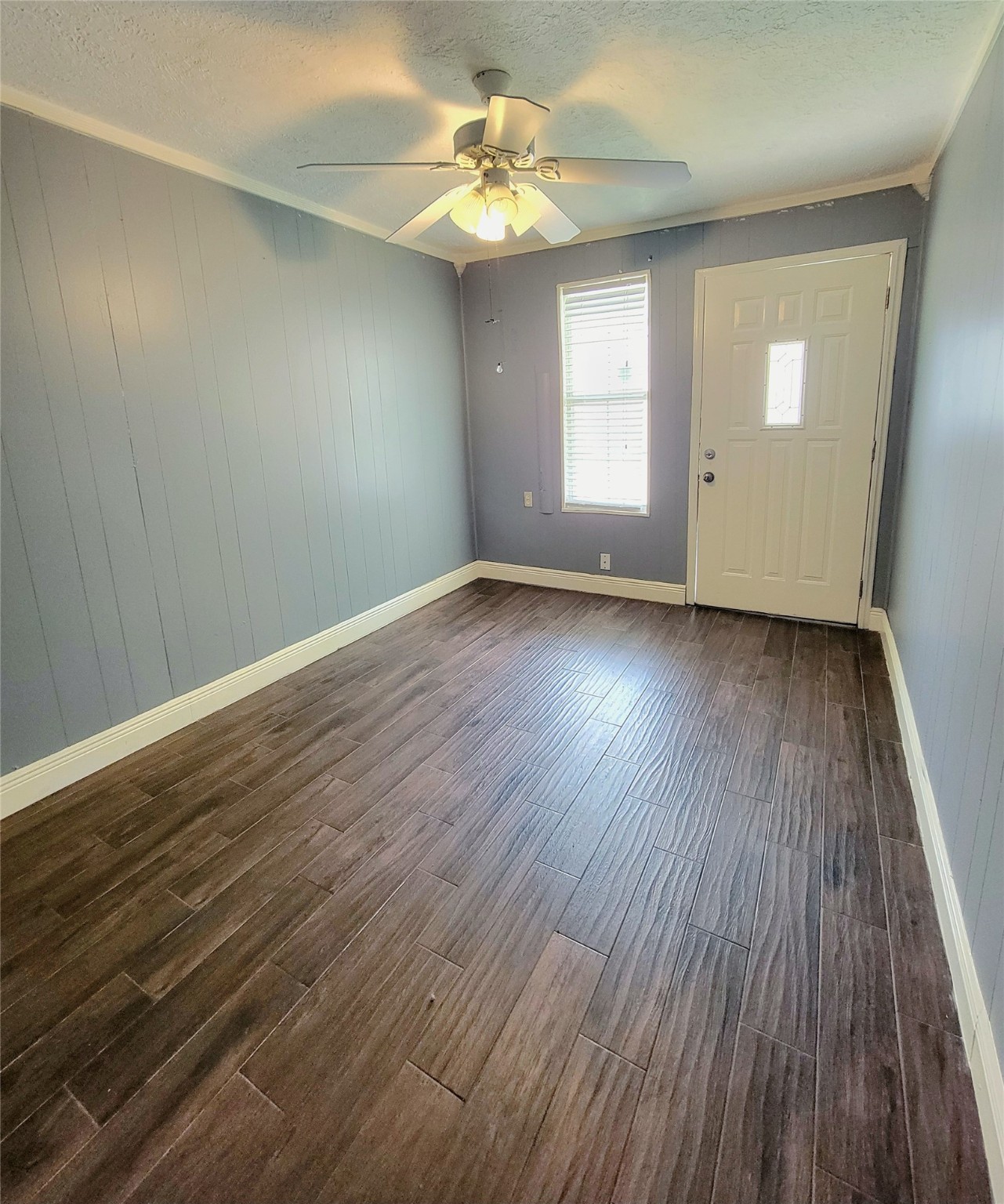4170 Amir Street Houston, TX 77072 - Photo 10 of 10 an empty room with wooden floor chandelier fan and windows