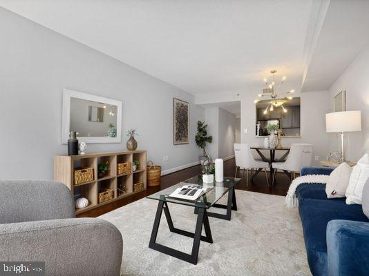 1150 K Street Northwest, Unit 709 Washington, DC 20005 - Photo 10 of 25 a living room with furniture a lamp and a chandelier