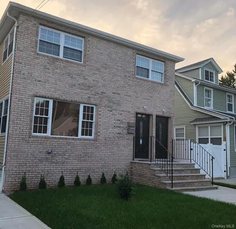 a brick house that has a lots of windows in it